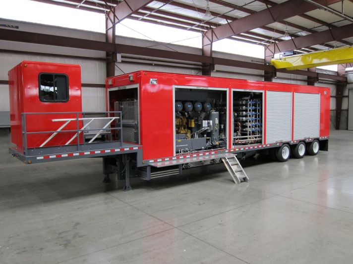 Large red enclosure for gas system mounted on a trailer