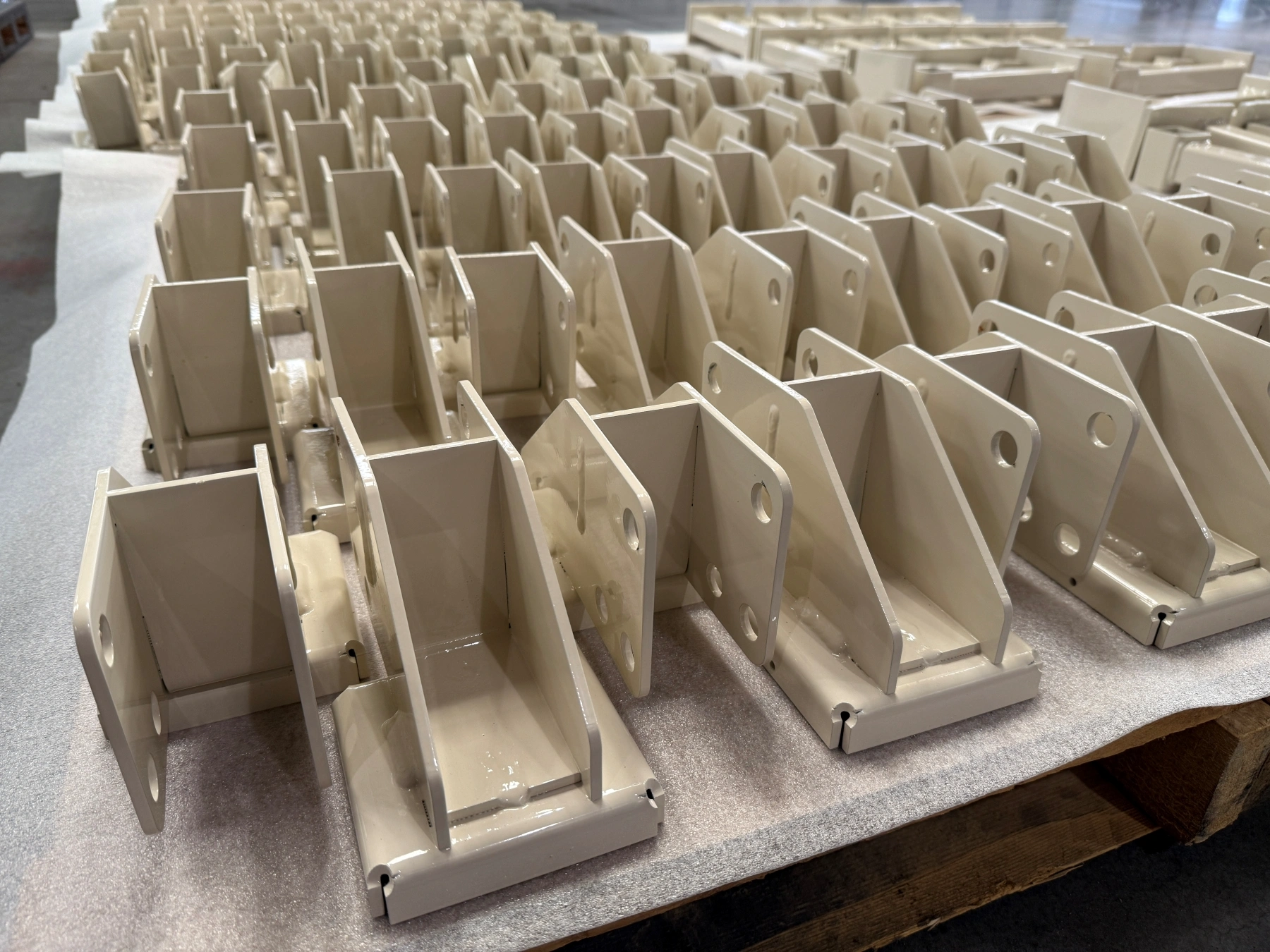Pallets of small, powder-coated weldments