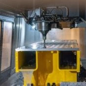 Close-up of a piece of plate being machined in a vertical machining center