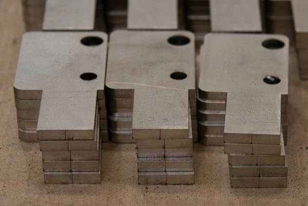 Stacks of small parts cut out of stainless steel plate